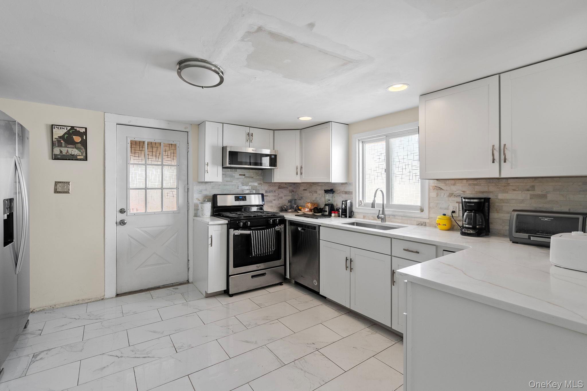 18-20 Spring Street Port Jervis, NY 12771 - Photo 8 of 46 a kitchen with a sink cabinets and stainless steel appliances