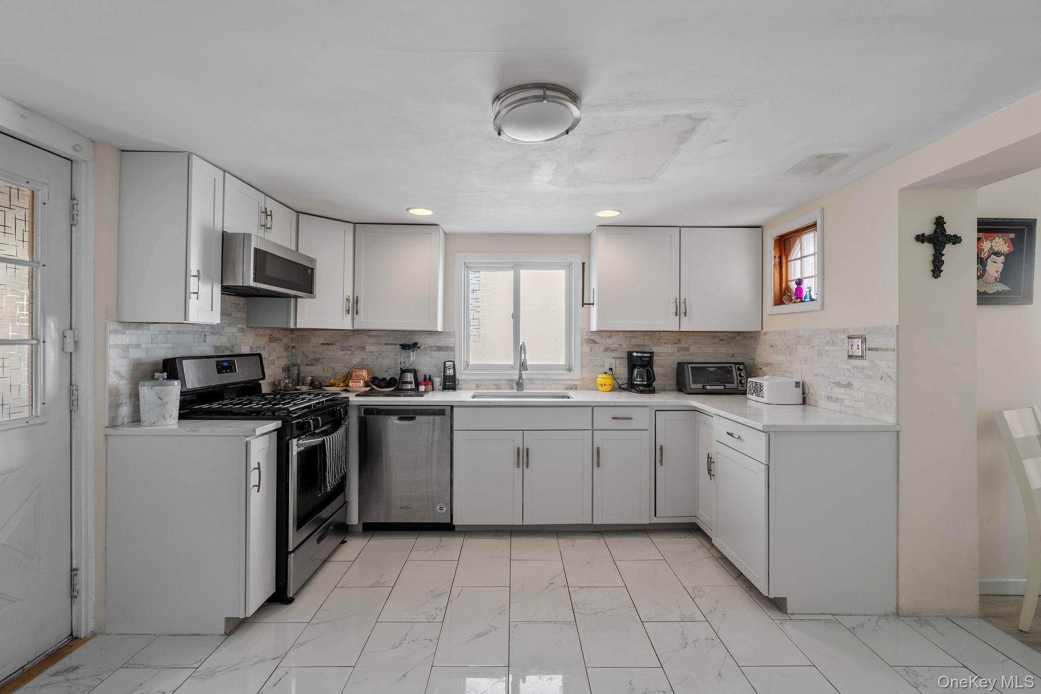 18-20 Spring Street Port Jervis, NY 12771 - Photo 9 of 46 a kitchen with cabinets appliances a sink and a counter top space