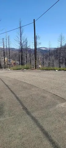 a view of a road with a fence