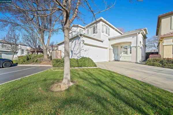 a front view of a house with a yard