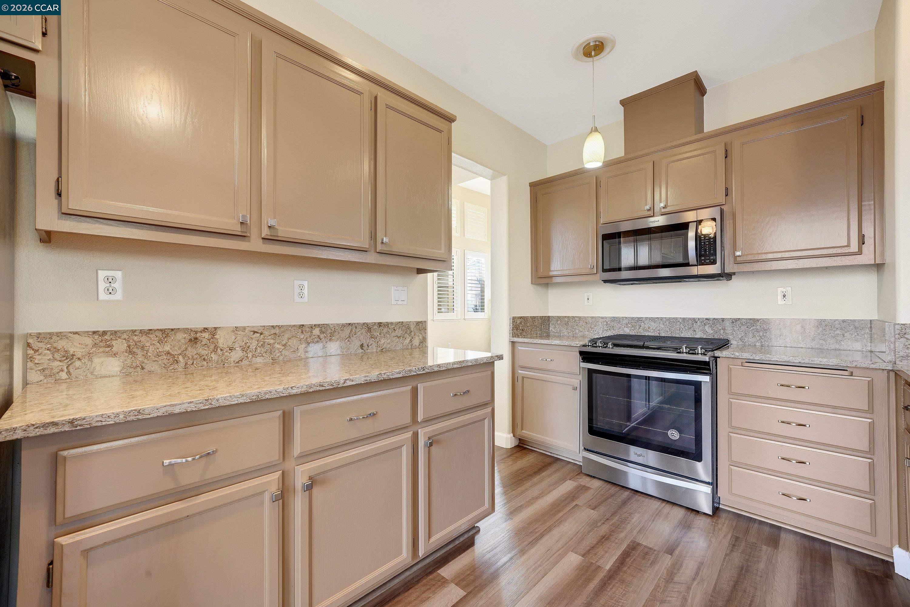 738 Marsh Place Fairfield, CA 94533 - Photo 11 of 45 a kitchen with granite countertop white cabinets stainless steel appliances and a sink
