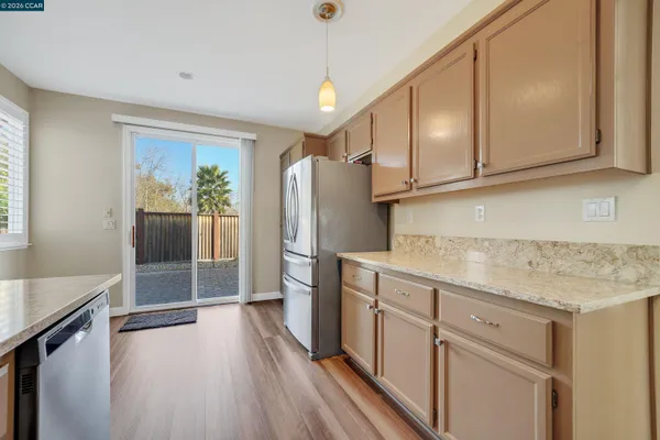 a kitchen with stainless steel appliances granite countertop a refrigerator sink and cabinets