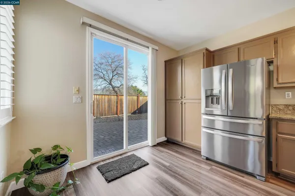 a kitchen with stainless steel appliances a refrigerator and a window