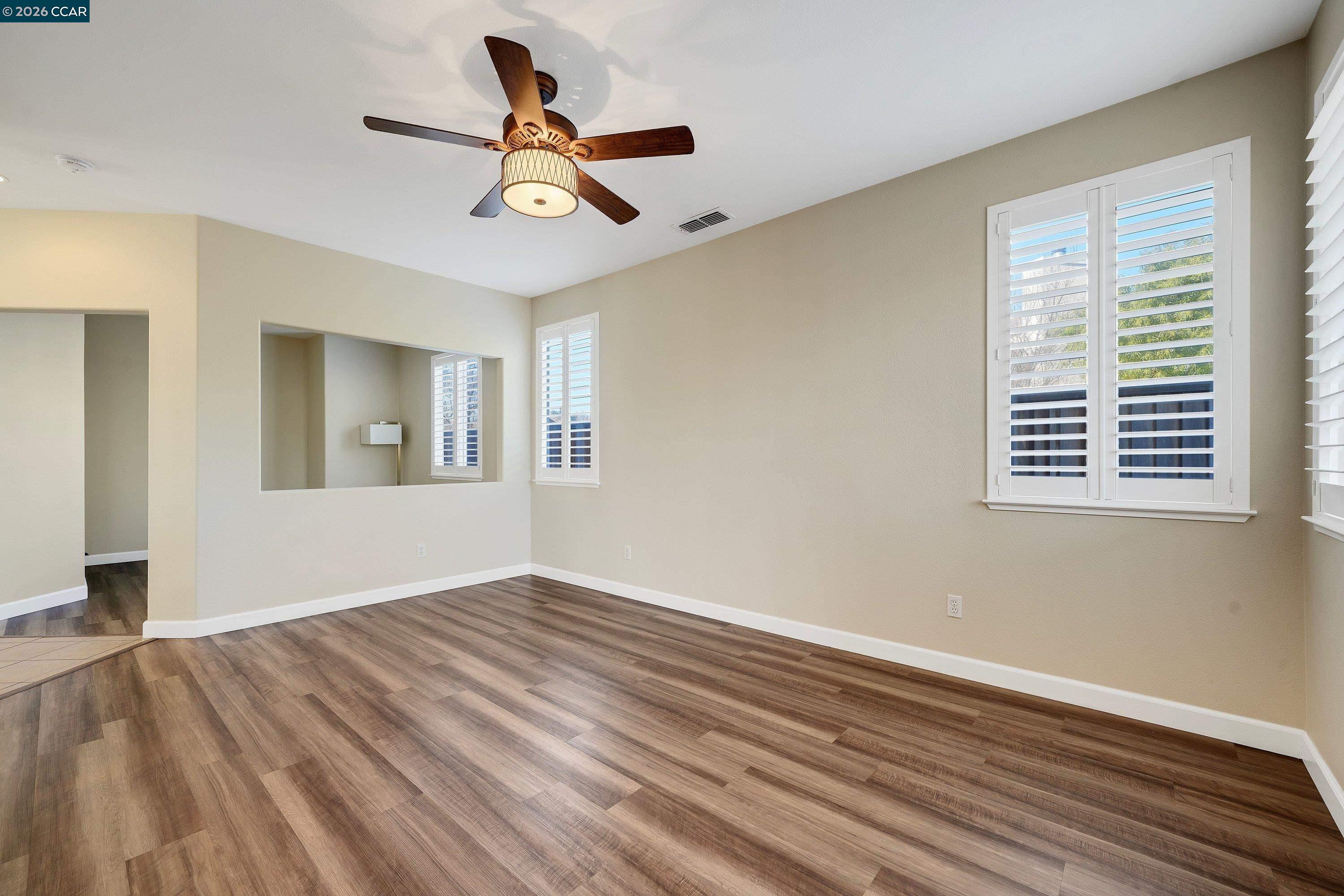738 Marsh Place Fairfield, CA 94533 - Photo 21 of 45 a view of empty room with wooden floor and fan