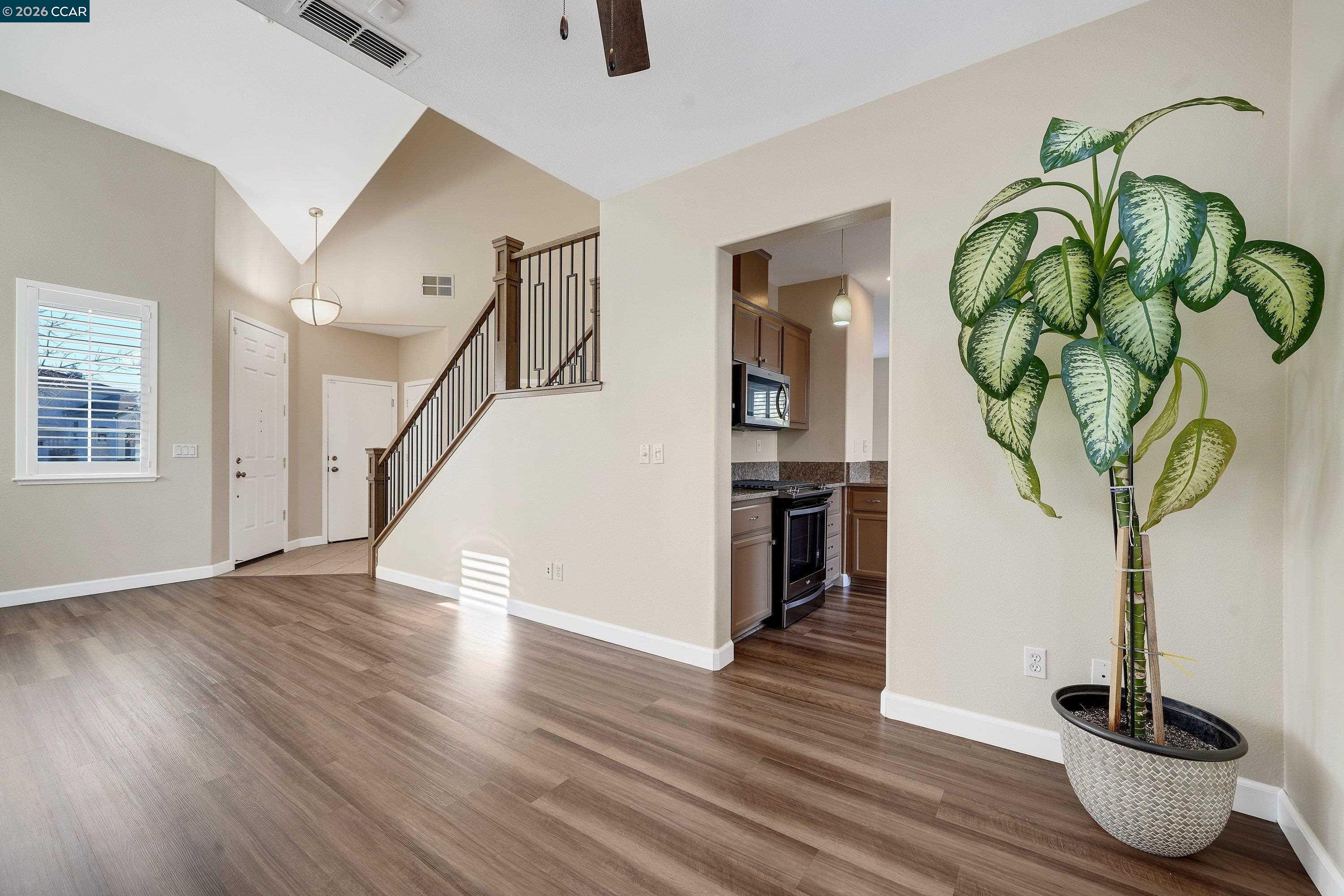 738 Marsh Place Fairfield, CA 94533 - Photo 9 of 45 a vase of flowers sitting on a table with wooden floor