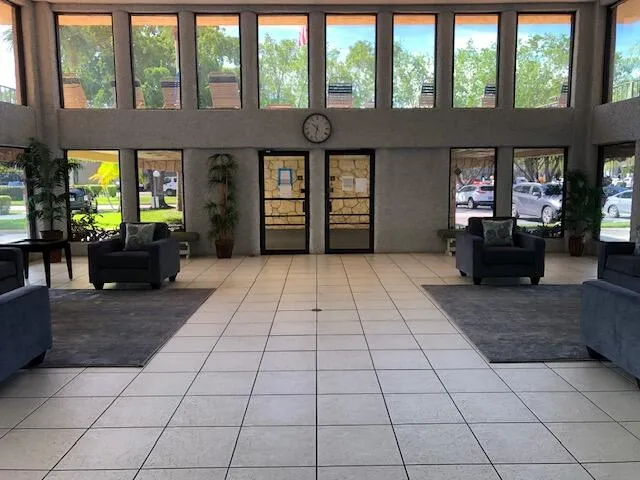 a living room with couches and large windows