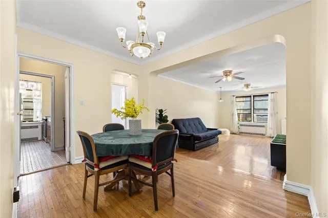 a view of a dining room with furniture wooden floor and chandelier