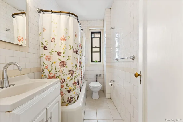 a bathroom with a sink a toilet and shower curtain