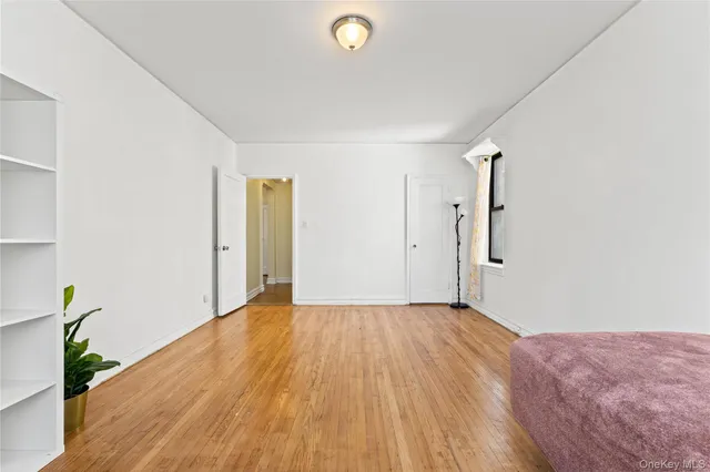 a view of an empty room and wooden floor