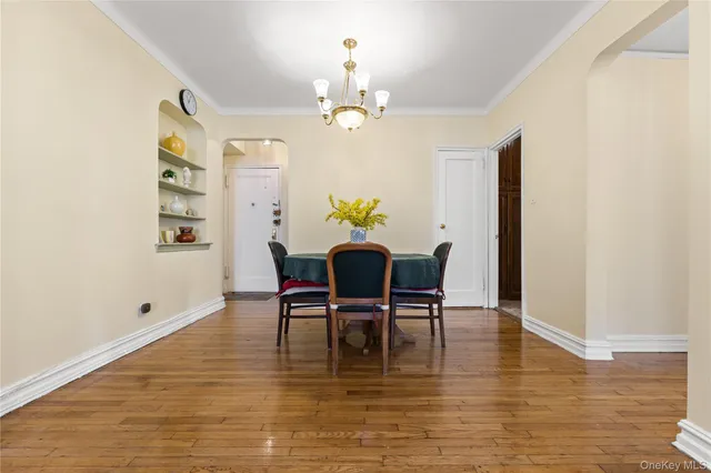a view of a dining room with furniture and chandelier