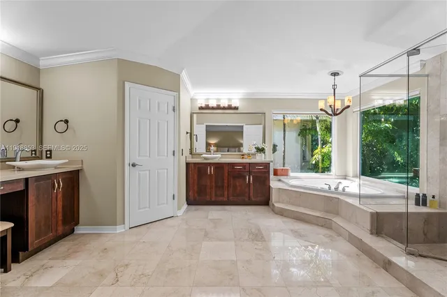 a spacious bathroom with a tub sink and mirror
