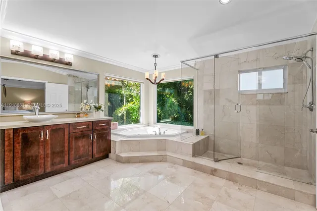 a spacious bathroom with a tub sink and mirror