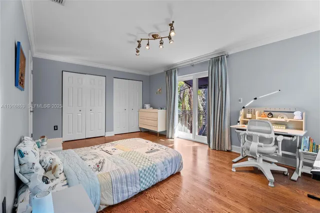 a bedroom with a large bed and a chandelier