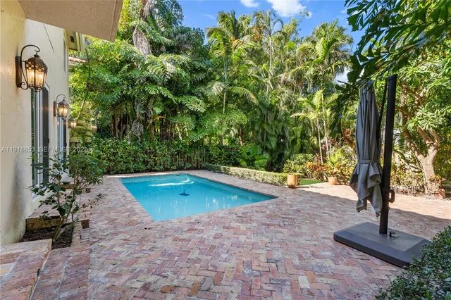 a view of a backyard with a tree