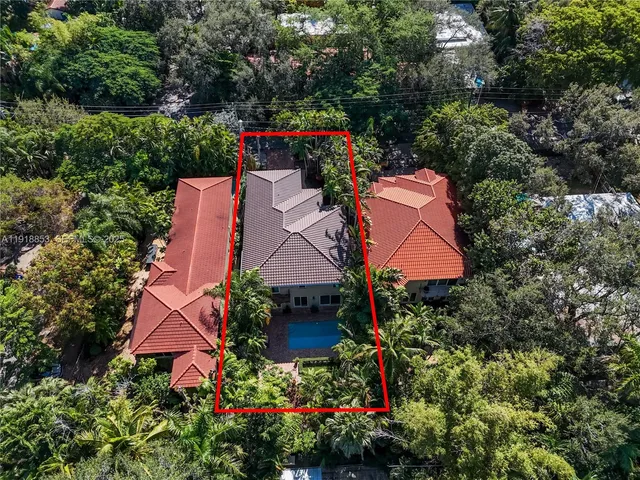 a view of a backyard with plants and a bench