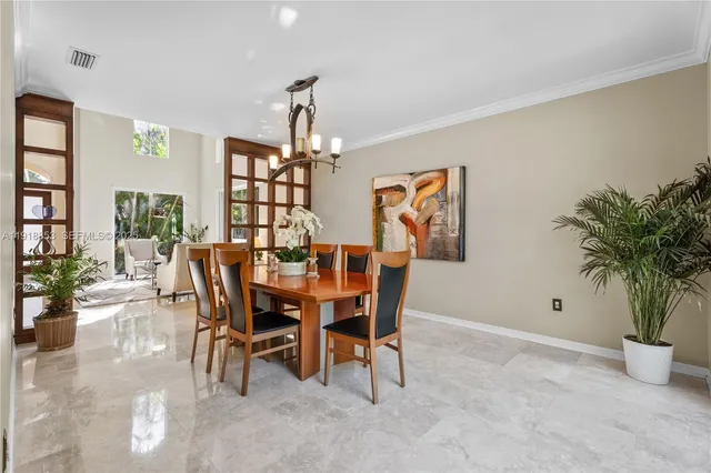 a view of a dining room with furniture and chandelier