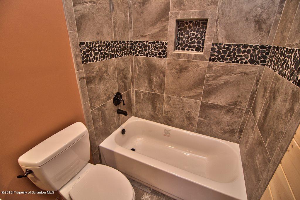 110 Highland Road Moscow, PA 18444 - Photo 44 of 88 a bathroom with a toilet and a bathtub