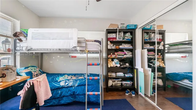 a bed room with a bed and a book shelf
