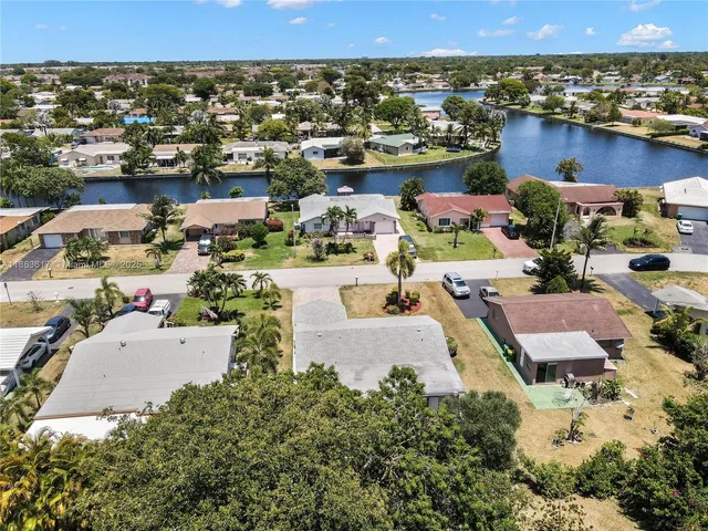 an aerial view of a house with a lake view