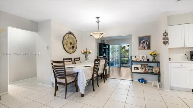 a view of dining room and kitchen with furniture wooden floor and a clock