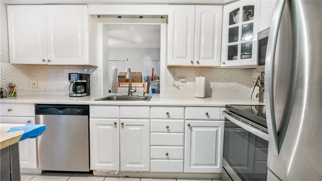 a kitchen with stainless steel appliances granite countertop a sink and cabinets