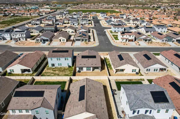 an aerial view of residential houses with outdoor space