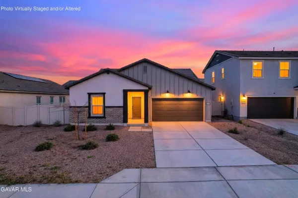 a backyard of a house with barbeque oven table and chairs