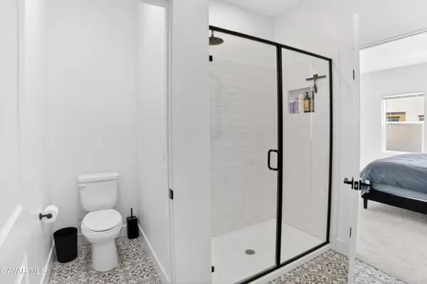 a bathroom with a shower toilet and a sink
