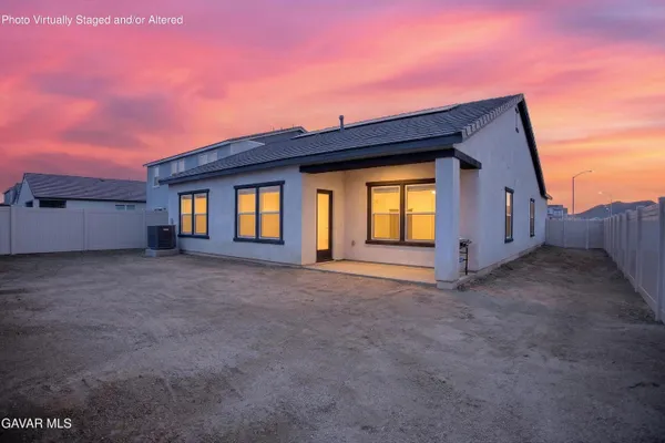 a view of a house with a dry yard and garage