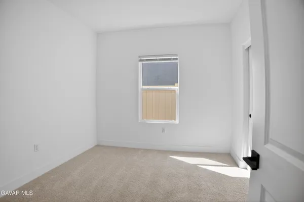 a view of a kitchen with a sink a counter space and wooden floor