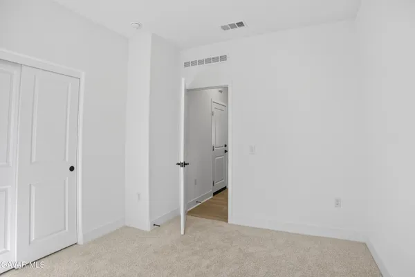 a open kitchen with stainless steel appliances kitchen island granite countertop a sink and a refrigerator