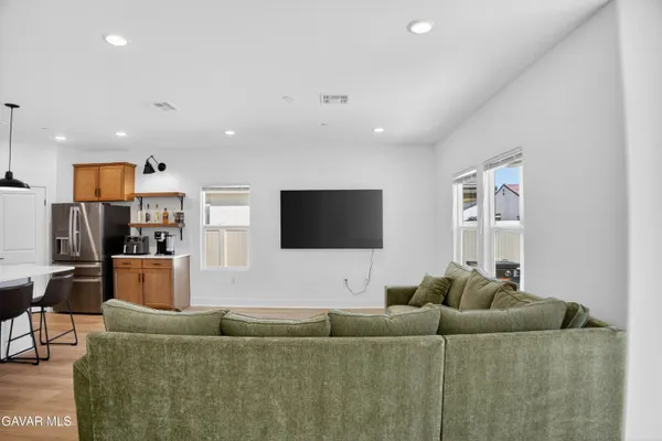 a living room with furniture and kitchen view