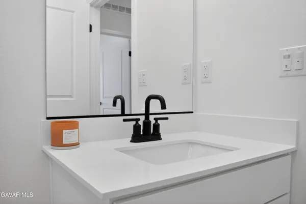 a close view of a sink a counter and utility room