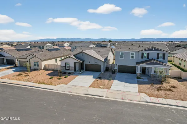 an aerial view of a house with a big yard and large trees