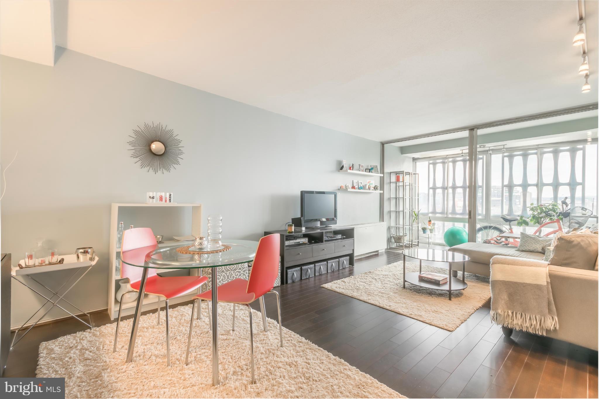 1301 Delaware Avenue Southwest, Unit N816 Washington, DC 20024 - Photo 1 of 20 a living room with furniture and a wooden floor