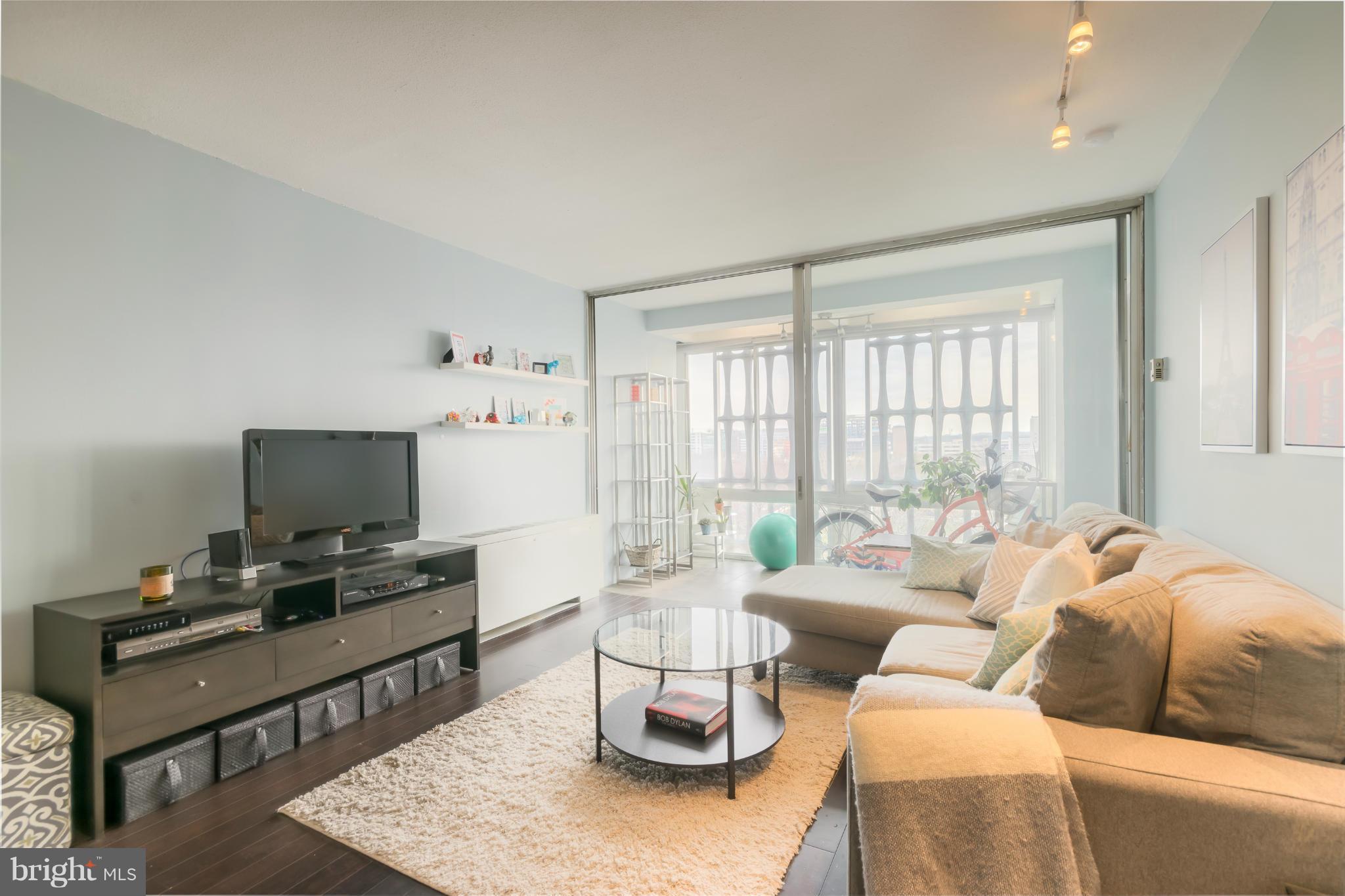 1301 Delaware Avenue Southwest, Unit N816 Washington, DC 20024 - Photo 2 of 20 a living room with furniture and a window