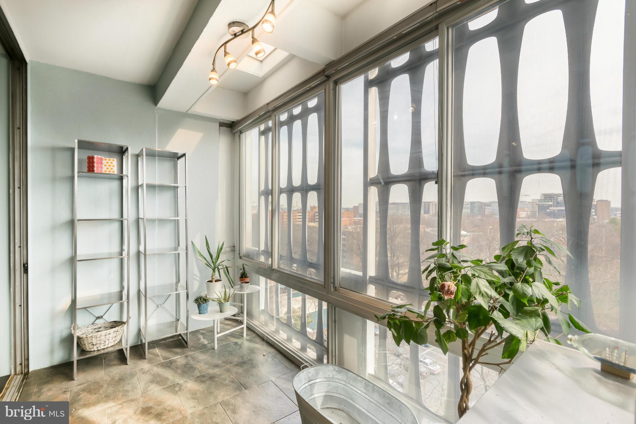 1301 Delaware Avenue Southwest, Unit N816 Washington, DC 20024 - Photo 13 of 20 a living room filled with furniture and a potted plant