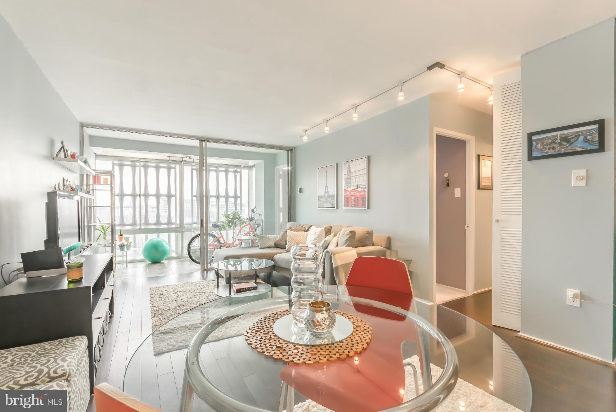 1301 Delaware Avenue Southwest, Unit N816 Washington, DC 20024 - Photo 5 of 20 a living room with furniture and a large window