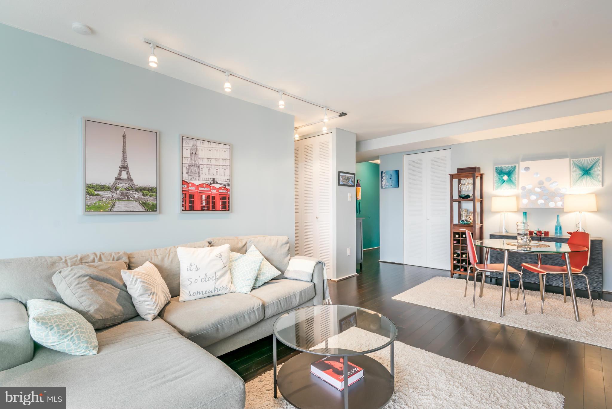 1301 Delaware Avenue Southwest, Unit N816 Washington, DC 20024 - Photo 7 of 20 a living room with furniture and wooden floor