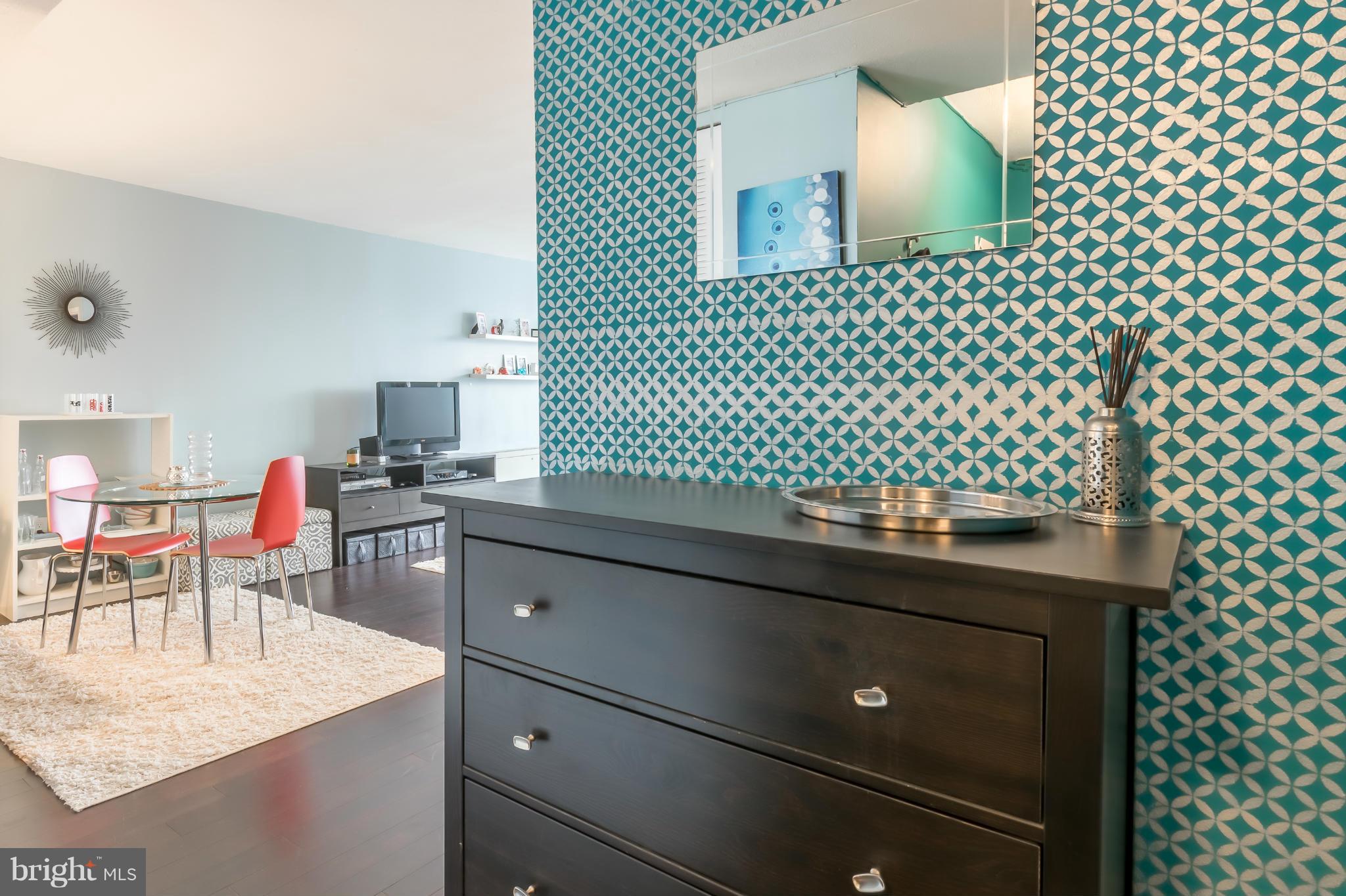 1301 Delaware Avenue Southwest, Unit N816 Washington, DC 20024 - Photo 8 of 20 a kitchen with a sink a table and chairs