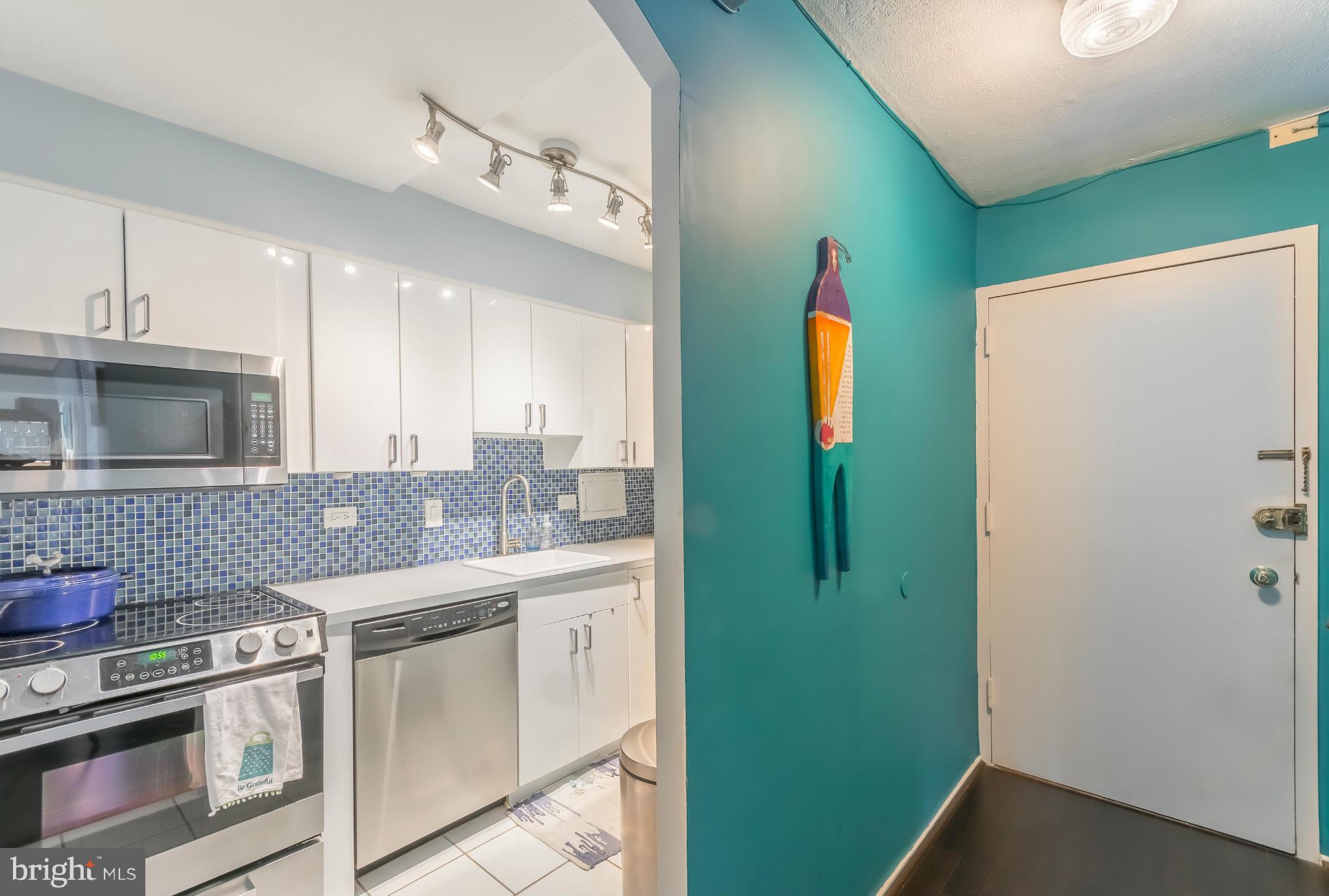 1301 Delaware Avenue Southwest, Unit N816 Washington, DC 20024 - Photo 9 of 20 a kitchen with stainless steel appliances granite countertop a refrigerator and a stove
