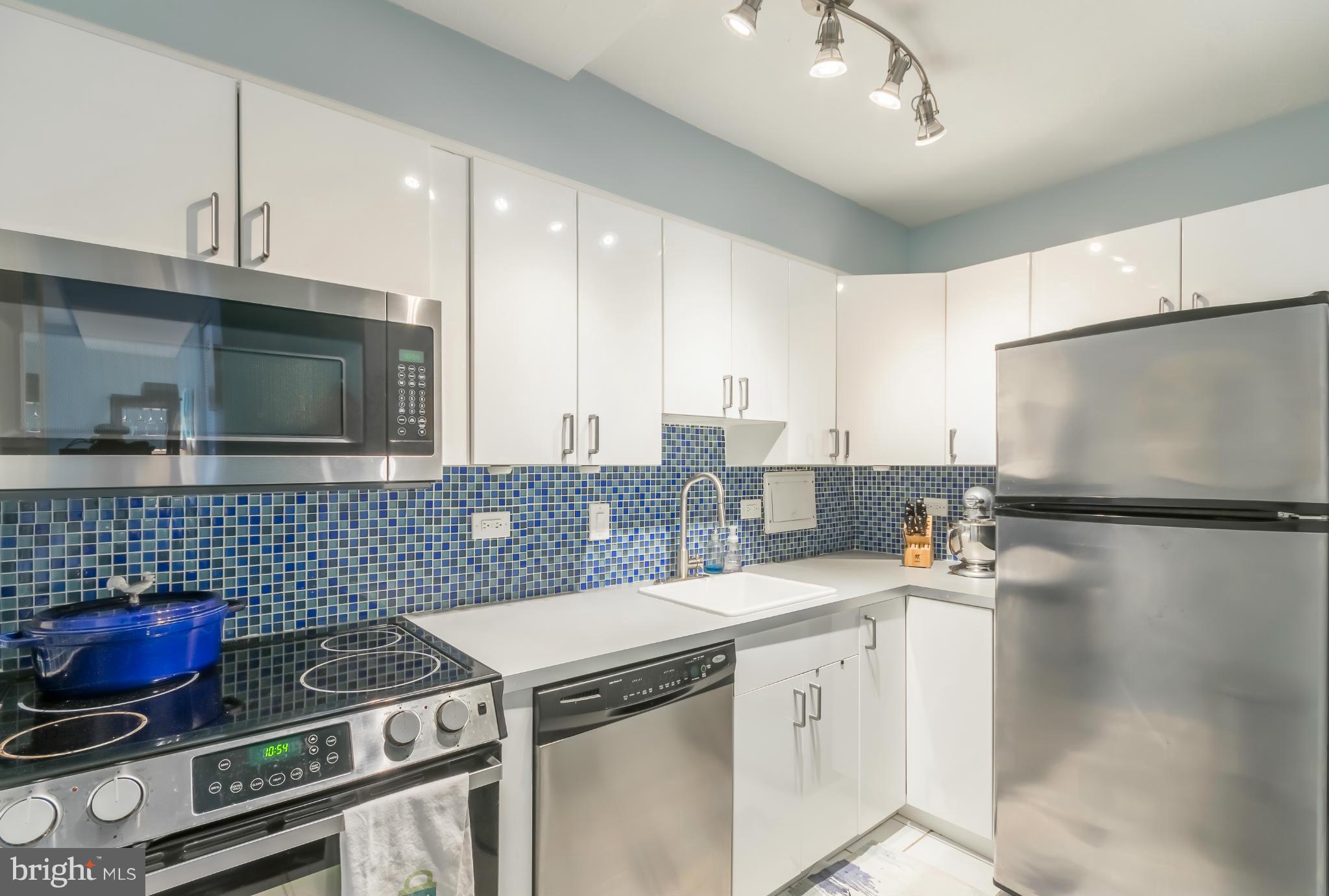 1301 Delaware Avenue Southwest, Unit N816 Washington, DC 20024 - Photo 10 of 20 a kitchen with a stove and a microwave