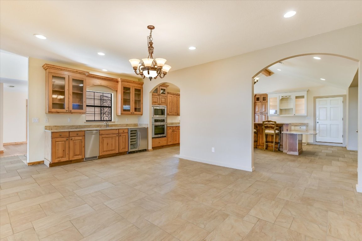116 Courtside Way Spicewood, TX 78669 - Photo 11 of 40 a view of a kitchen with a sink cabinet and a living room
