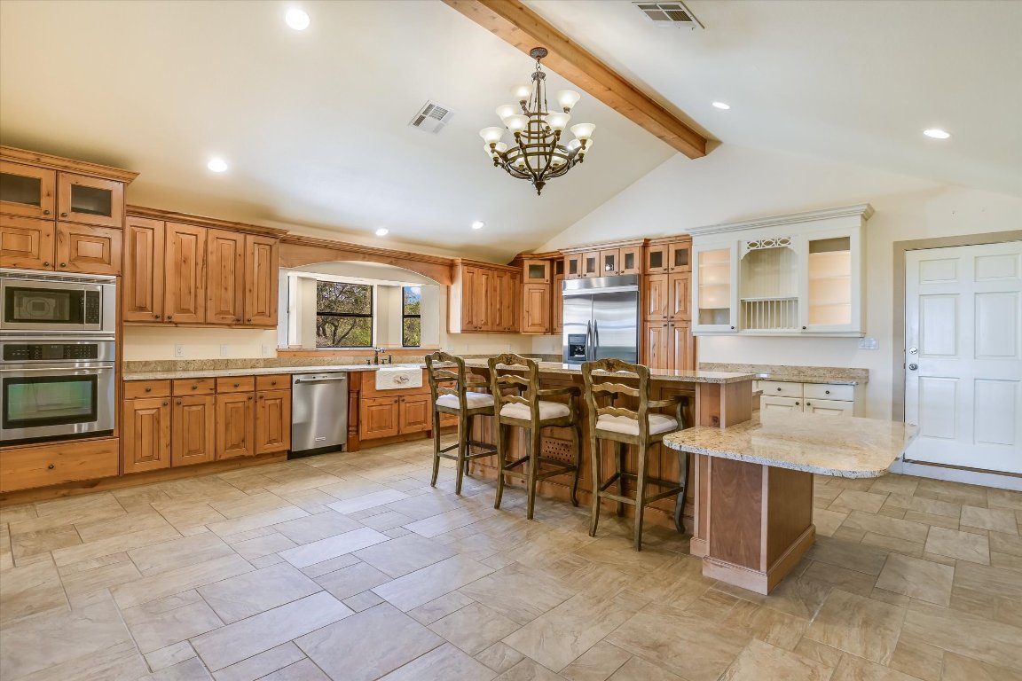 116 Courtside Way Spicewood, TX 78669 - Photo 13 of 40 a group of people sitting in a kitchen