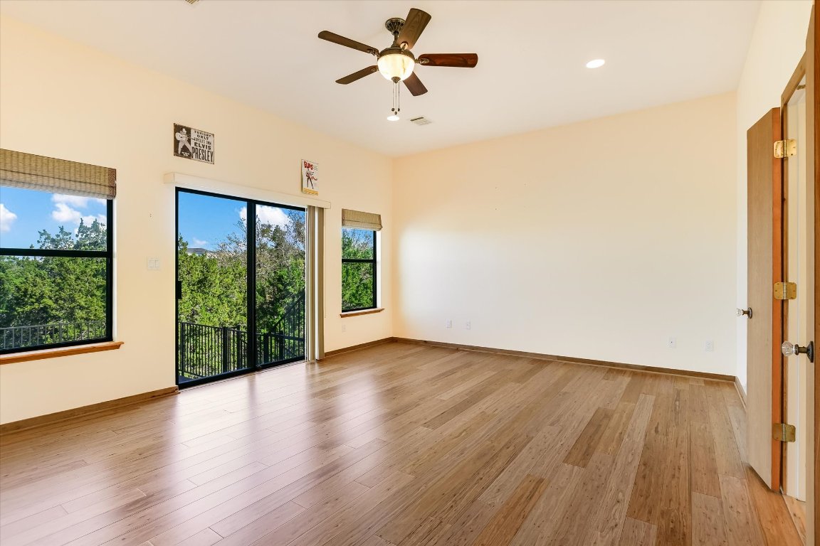 116 Courtside Way Spicewood, TX 78669 - Photo 17 of 40 a view of empty room with wooden floor and fan