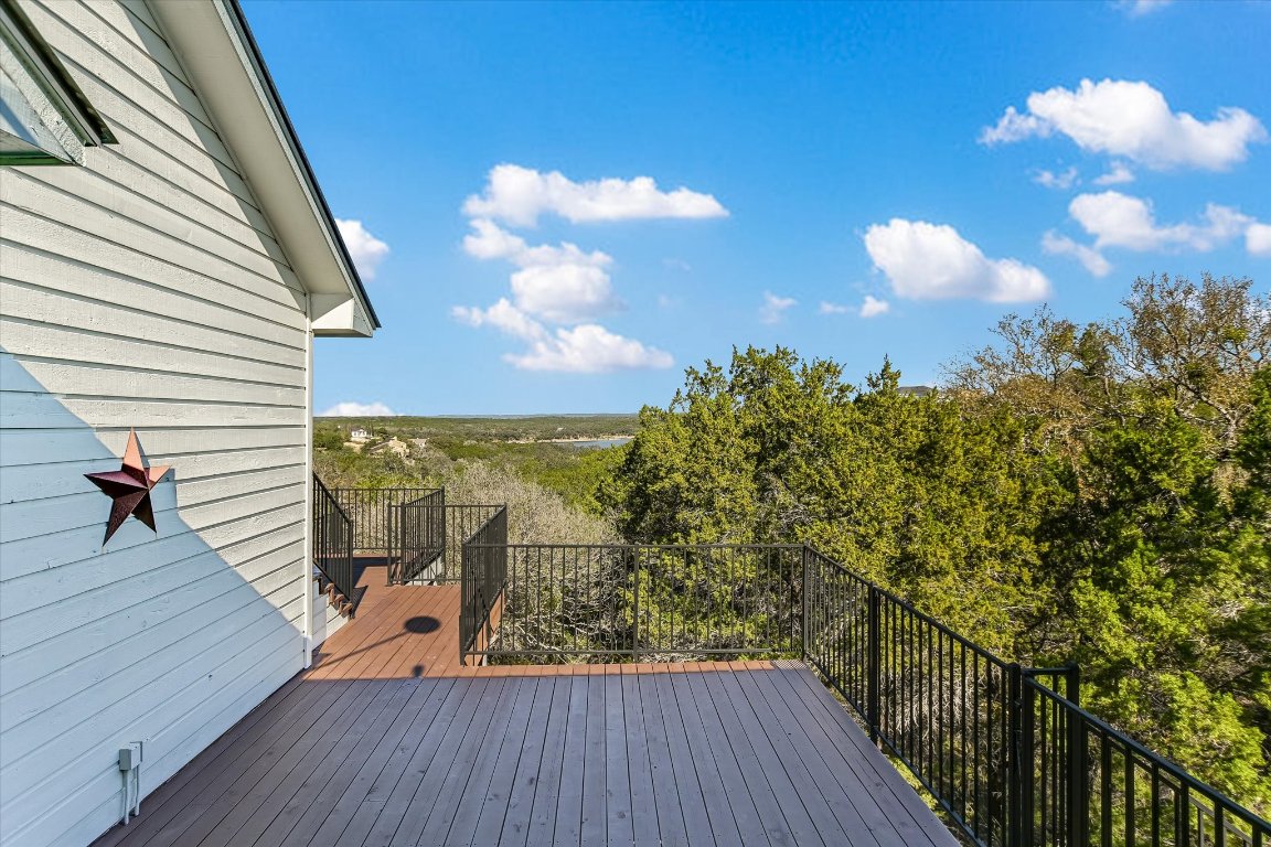 116 Courtside Way Spicewood, TX 78669 - Photo 18 of 40 a view of a balcony with wooden floor