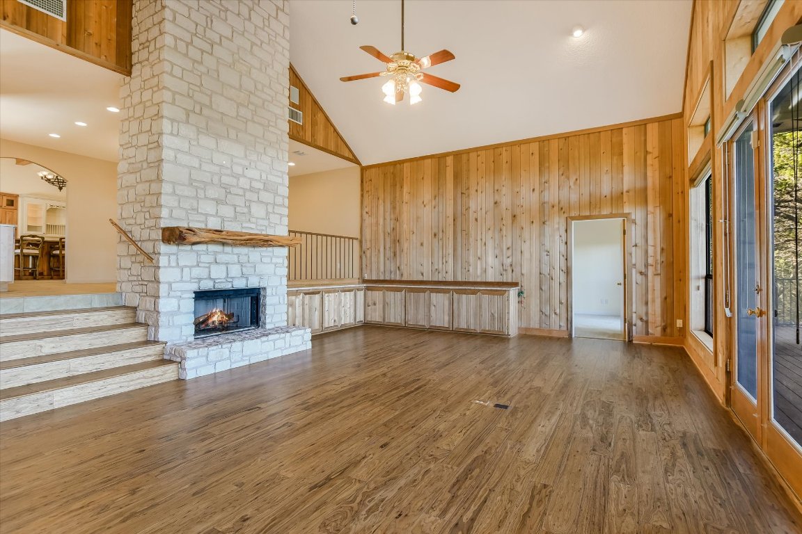 116 Courtside Way Spicewood, TX 78669 - Photo 4 of 40 a view of a livingroom with wooden floor a ceiling fan and windows