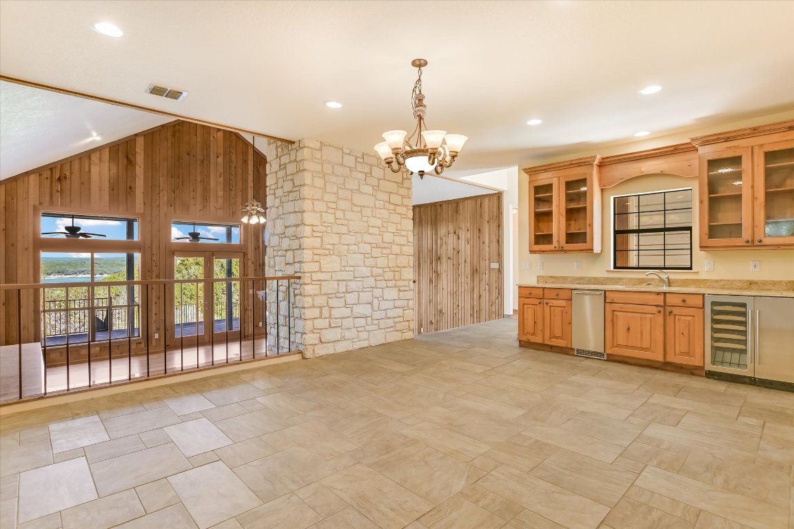 116 Courtside Way Spicewood, TX 78669 - Photo 10 of 40 a view of an empty room with a kitchen