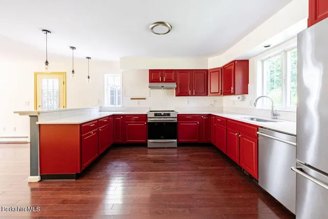 a view of a hallway with wooden floor and glass door