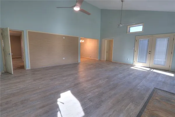 a view of an empty room with wooden floor